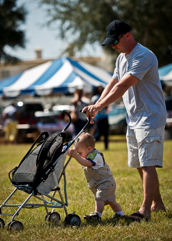 Douglas Lambert Jr helps his dad, a Reservist with the 919th Communications Squadron, push around a stroller at Duke Field’s Family Day event Oct. 13.  The 919th Special Operations Wing sets aside a special day each year to show appreciation for its reservists and their family members.  Events include food, music, sports, children’s games, etc.  (U.S. Air Force photo/Tech. Sgt. Samuel King Jr.)