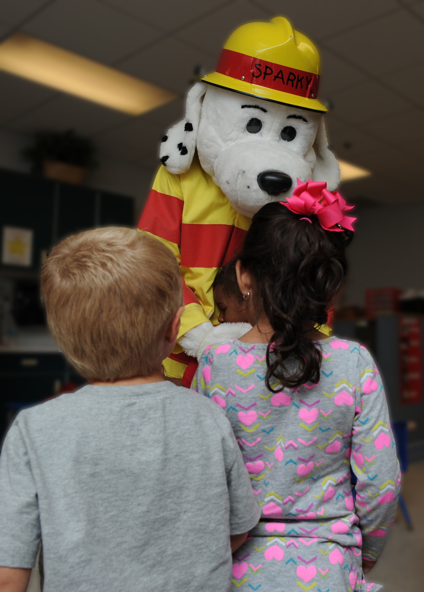Sparky the fire dog visits children in the Child Development Center during Fire Prevention Week Oct. 9, 2012, at Dyess Air Force Base, Texas. Sparky is a nationwide mascot that fire departments use to promote fire prevention and fire safety. Every October, fire departments throughout the country host fire education and awareness known as, Fire Prevention Week. This year’s theme is "Have Two Ways Out," encouraging families to reevaluate their exit strategies and incorporate a second exit. Fire Prevention Week was established to commemorate the Great Chicago Fire of 1871. (U.S. Air Force photo by Airman 1st Class Jonathan Stefanko/ Released)