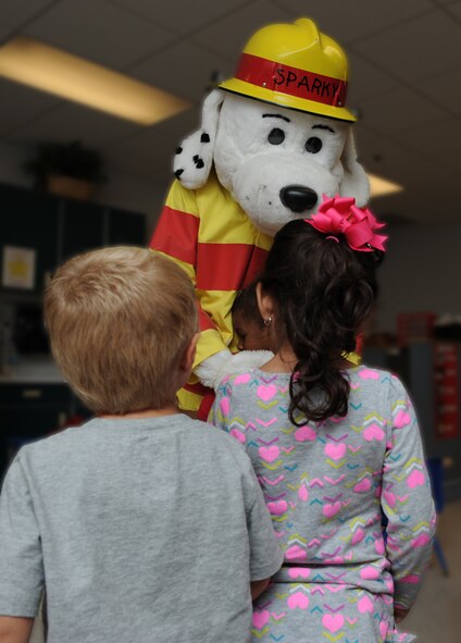 Sparky the fire dog visits children in the Child Development Center during Fire Prevention Week Oct. 9, 2012, at Dyess Air Force Base, Texas. Sparky is a nationwide mascot that fire departments use to promote fire prevention and fire safety. Every October, fire departments throughout the country host fire education and awareness known as, Fire Prevention Week. This year’s theme is "Have Two Ways Out," encouraging families to reevaluate their exit strategies and incorporate a second exit. Fire Prevention Week was established to commemorate the Great Chicago Fire of 1871. (U.S. Air Force photo by Airman 1st Class Jonathan Stefanko/ Released)
