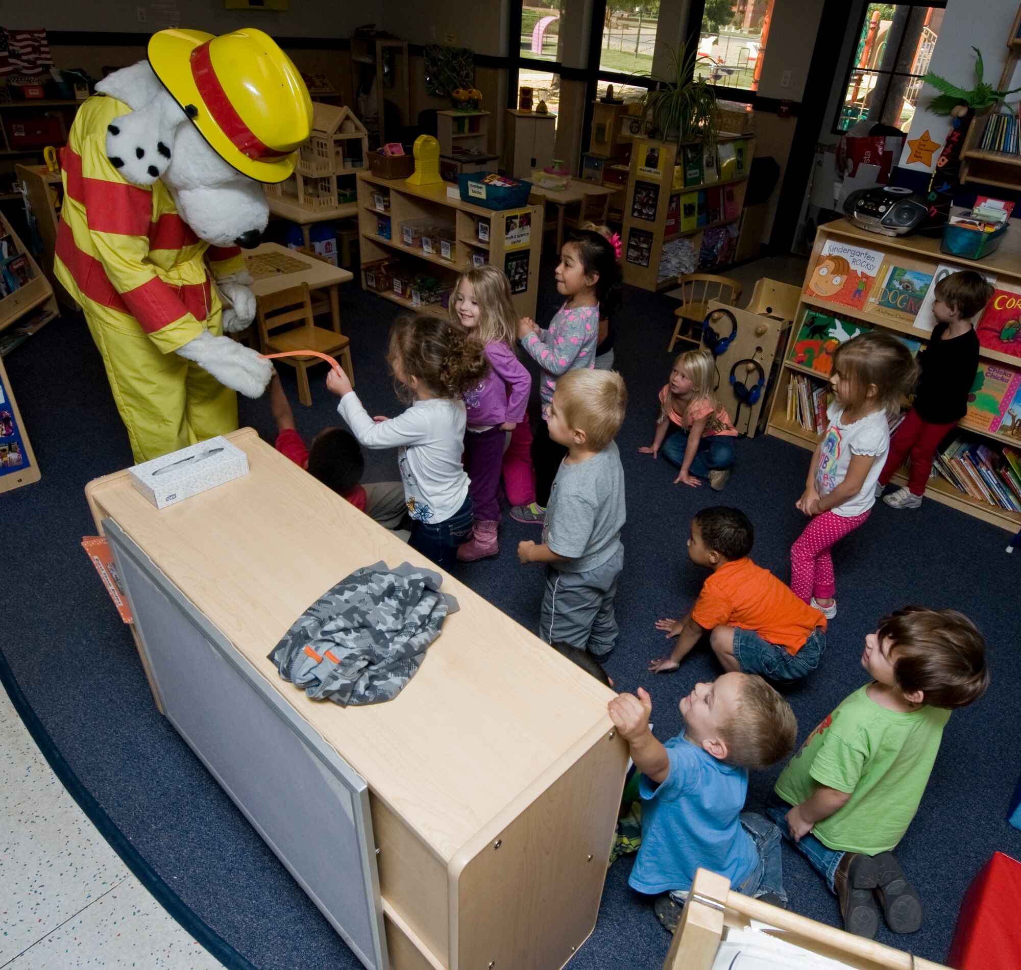 Sparky the fire dog visits children at the Child Development Center during Fire Prevention Week Oct. 9, 2012, at Dyess Air Force Base, Texas. Sparky is a nationwide mascot that fire departments use to promote fire prevention and fire safety. Every October, fire departments throughout the country host fire education and awareness known as, Fire Prevention Week. This year’s theme is "Have Two Ways Out," encouraging families to reevaluate their exit strategies and incorporate a second exit. Fire Prevention Week was established to commemorate the Great Chicago Fire of 1871. (U.S. Air Force photo by Airman 1st Class Jonathan Stefanko/ Released)
