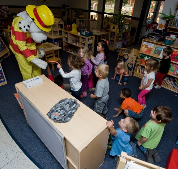 Sparky the fire dog visits children at the Child Development Center during Fire Prevention Week Oct. 9, 2012, at Dyess Air Force Base, Texas. Sparky is a nationwide mascot that fire departments use to promote fire prevention and fire safety. Every October, fire departments throughout the country host fire education and awareness known as, Fire Prevention Week. This year’s theme is "Have Two Ways Out," encouraging families to reevaluate their exit strategies and incorporate a second exit. Fire Prevention Week was established to commemorate the Great Chicago Fire of 1871. (U.S. Air Force photo by Airman 1st Class Jonathan Stefanko/ Released)