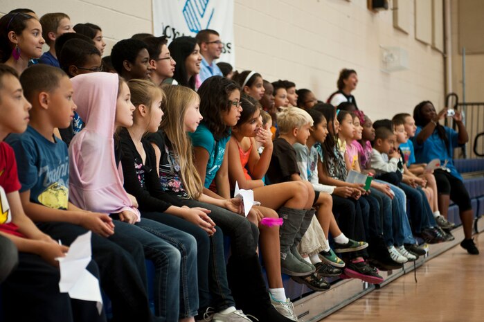 Children at the Youth Center watch a performance by the United States Air Force Band of The Golden West Oct. 12, 2012, at Nellis Air Force Base, Nev. Members of the band played a variety of songs and demonstrated how each instrument is played. (U.S. Air Force photo by Airman 1st Class Jason Couillard)