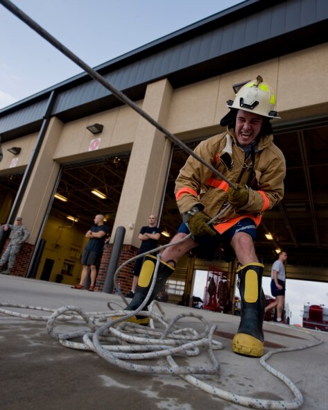 An Airman from the 7th Security Forces Squadron pulls a sled during the fireman’s challenge Oct. 12, 2012, at Dyess Air Force Base, Texas. Challenges included a farmer’s walk, utility pull, sled pull and more that a fireman may have to endure during an emergency. Every October, fire departments throughout the country host fire education and awareness known as, Fire Prevention Week. This year’s theme is "Have Two Ways Out," encouraging families to reevaluate their exit strategies and incorporate a second exit. Fire Prevention Week was established to commemorate the Great Chicago Fire of 1871. (U.S. Air Force photo by Airman 1st Class Jonathan Stefanko/ Released)