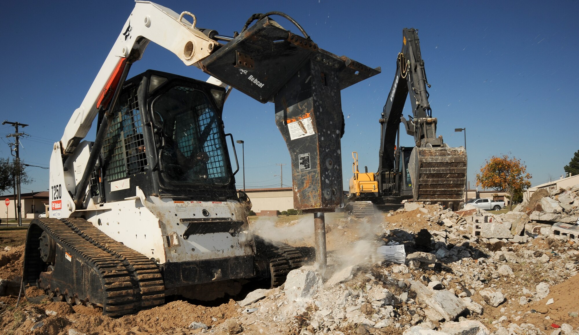 Members of the 22nd Civil Engineer Squadron horizontal shop tear down Building 701 in an effort to reach the United States Air Force’s 20/20 by 2020 goal Oct. 16, 2012, McConnell Air Force Base, Kan. The 20/20 by 2020 goal asks civil engineer squadrons to assist in reducing base energy use 20 percent by 2020. Part of this initiative includes the demolition of inefficient buildings. (U.S. Air Force photo/Airman 1st Class Jose L. Leon)