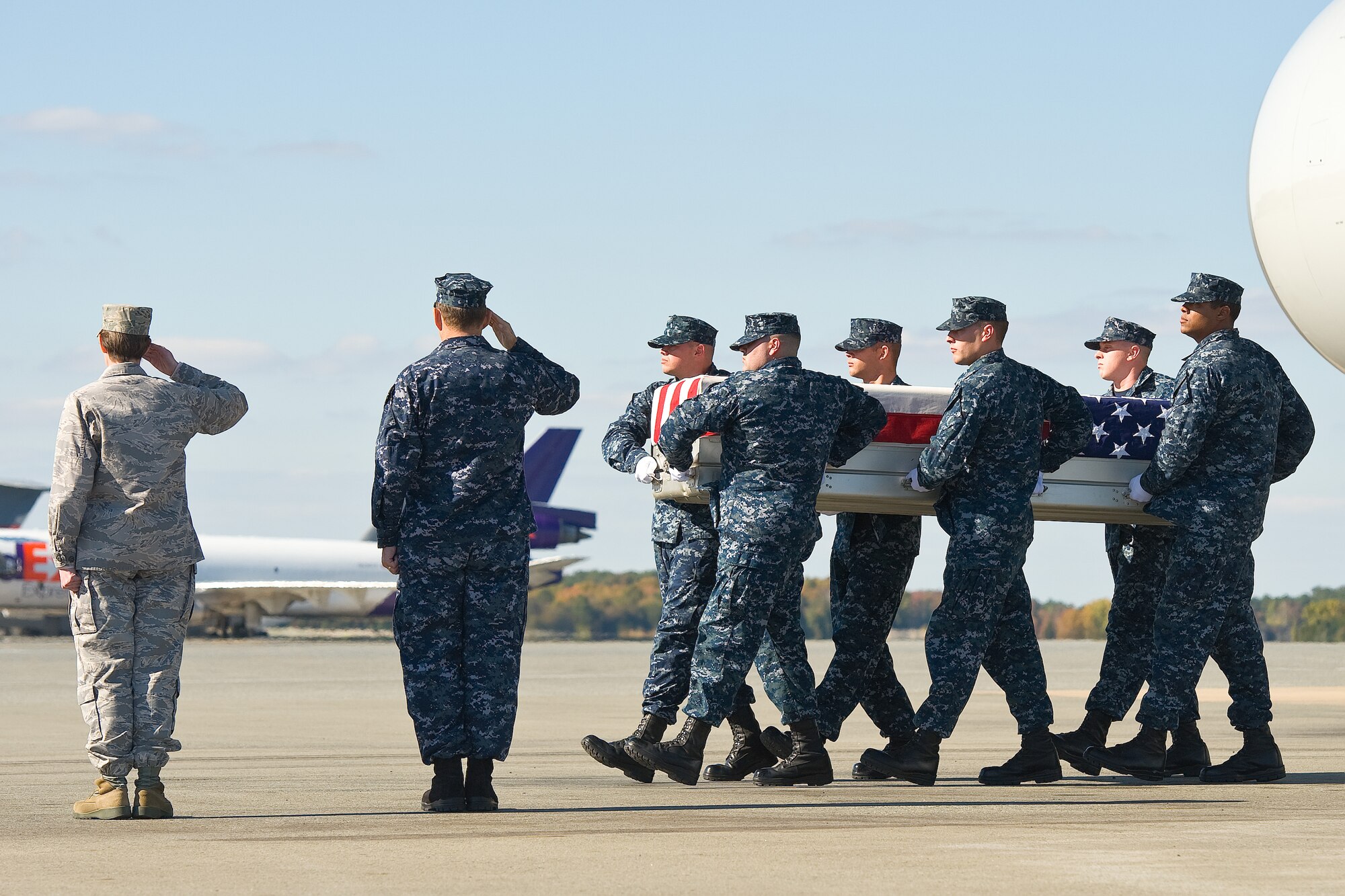 A U.S. Navy carry team transfers the remains of Navy Cmdr. Joel Del Mundo Tiu, of Manila, Philippines, at Dover Air Force Base, Del., Oct. 16, 2012. Tiu was assigned to Logistics Forces, U.S. Naval Forces Central Command, Manama, Bahrain. (U.S. Air Force photo/Roland Balik)
