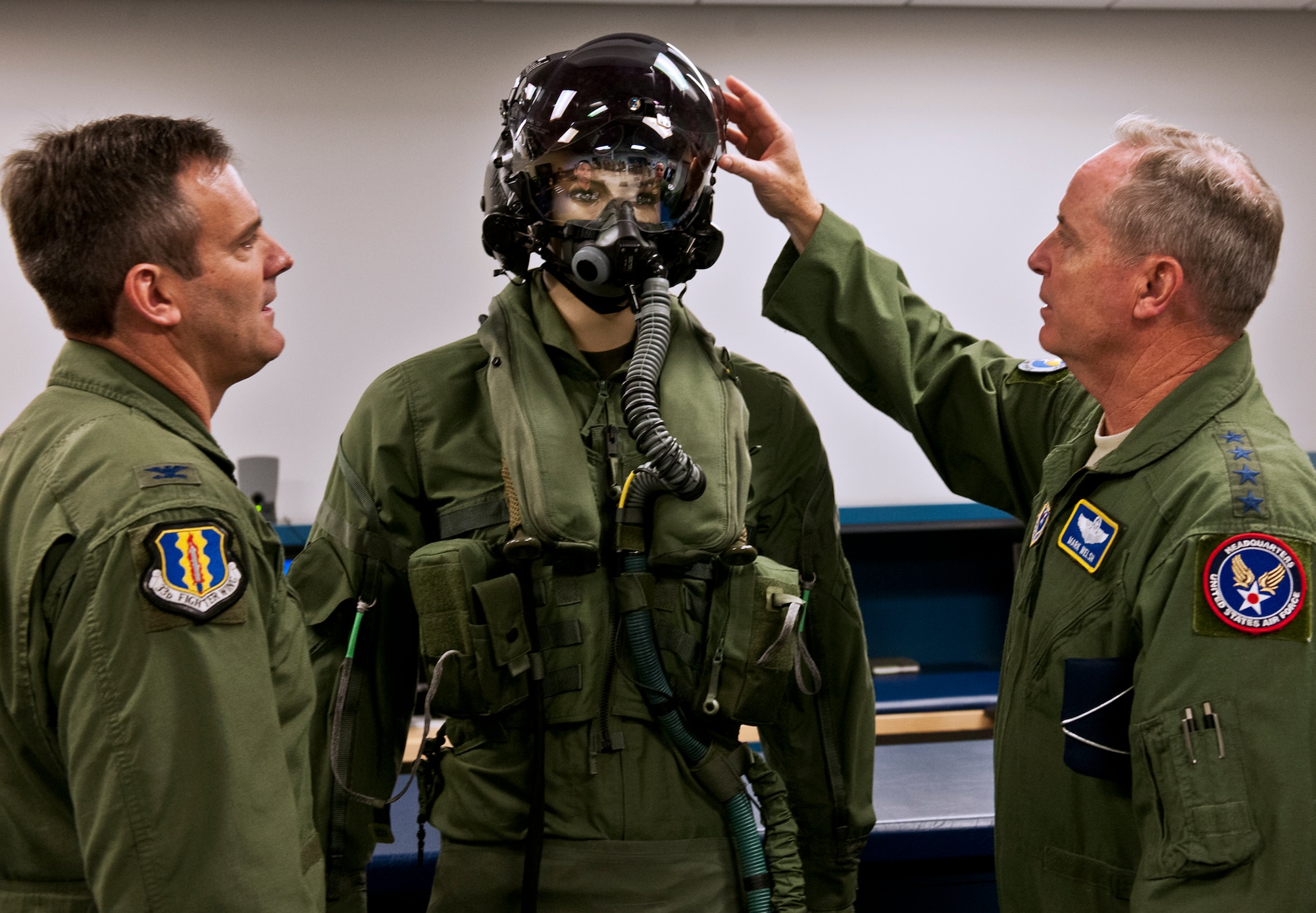 Air Force Chief of Staff Gen. Mark A. Welsh III examines the helmet-mounted display system and flight suit used for the F-35A Lightning II with Col. Andrew Toth, 33rd Fighter Wing commander during his visit to the wing at Eglin Air Force Base, Fla., Oct. 16. During an immersion at the integrated training center for the fifth generation aircraft, Welsh said he considers the joint strike fighter mission and its future one of his top priorities so he wanted to see the operation and training firsthand. The 33rd Fighter Wing's unique environment is comprised of military, civilians and contractors at Eglin, who will train pilots and maintainers for all three variants of the F-35 for the Air Force, Navy and Marines. (U.S. Air Force photo/Samuel King Jr.)