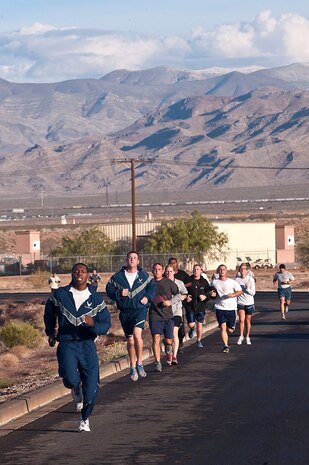 Airmen of the 820th RED HORSE, run towards the finish line during the RED HORSE 8.2 kilometer birthday run Oct. 12, 2012, at Nellis Air Force Base, Nev.   The celebration marks the 47th birthday of RED HORSE. (U.S. Air Force photo by Staff Sgt. Christopher Hubenthal)