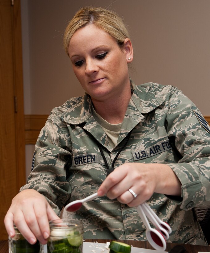 Staff Sgt. Christine Green, 28th Logistics Readiness Squadron inventory NCO in charge, adds salt to a jar of cucumber slices during a canning workshop at the Airman and Family Readiness Center on Ellsworth Air Force Base, S.D., Oct. 11, 2012. The salt is part of the pickling process, and is added when a food contains sufficient moisture. (U.S. Air Force photo by Airmen 1st Class Kate Thornton-Maurer/Released)
