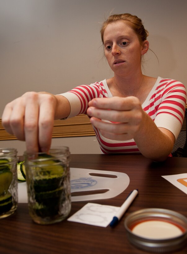 Catherine Croteau, spouse of Senior Airman Keith Croteau, 28th Security Forces Squadron defender, places cucumber slices into a jar during a canning workshop at the Airman and Family Readiness Center on Ellsworth Air Force Base, S.D., Oct. 11, 2012. Students were taught how to make pickles along with proper canning methods for a variety of foods and sauces, including jellies, jams, fruits, vegetables, salsa and spaghetti sauce. (U.S. Air Force photo by Airmen 1st Class Kate Thornton-Maurer/Released)