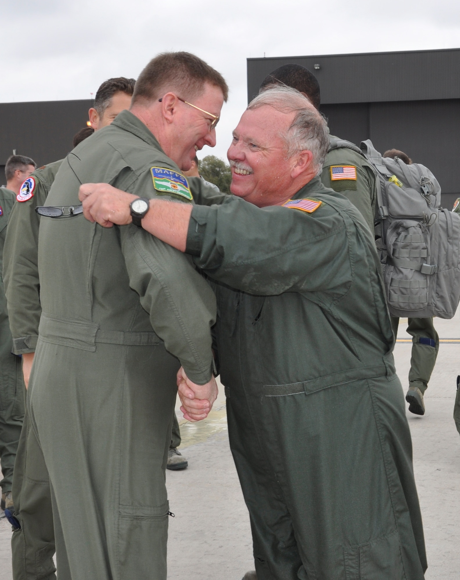 Fellow Air Force Reserve 731st Airlift Squadron flight engineer, Senior Master Sgt. Dave Carey is one of the first to congratulate Chief Master Sgt. Tom Farley after Farley’s Sept. 27, 2012 “fini flight” at Peterson Air Force Base, Colo.  Farley will retire from the Air Force Reserve after 33 years of service and more than 11,300 flying hours. (U.S. Air Force photo/Ann Skarban)