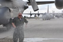Chief Master Sgt. Tom Farley is “hosed” down after his final flight as an Air Force Reserve C-130 flight engineer on Sept. 27, 2012 at Peterson Air Force Base, Colo.  Farley will retire from the Air Force Reserve after 33 years of service and more than 11,300 flying hours. (U.S. Air Force photo/Ann Skarban)