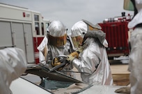 A firefighter from the 902nd Civil Engineer Squadron demonstrates extrication techniques for Airmen and family members at a Fire Prevention Week celebration Oct. 13 at Joint Base San Antonio-Randolph. (U.S. Air Force photo by Josh Rodriguez)