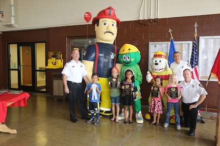 Student from the Randolph Elementary School pose for a photo with the Fire Chief and Fire Inspector at a Fire Prevention Week celebration Oct. 13 at Joint Base San Antonio-Randolph. The students were the winners of the poster contest at Joint Randolph Elementary School. (U.S. Air Force photo by Josh Rodriguez)