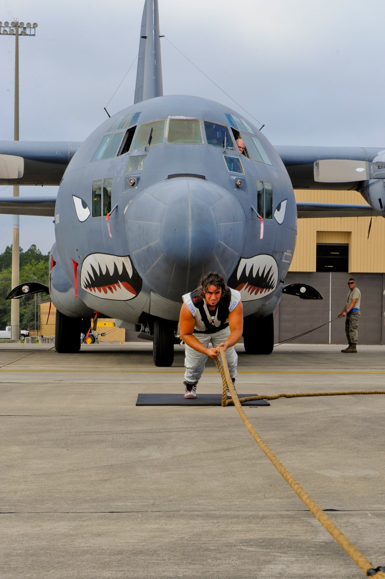 Mark Kirsch, strong man for "Man vs. Jumbo Jets", pulls an HC-130 Combat King during practice pulls at Moody Air Force Base, Ga., Oct. 5, 2012. The practice allows him to get a feel for the aircraft and a survey of the surface he will be using during the upcoming open house. (U.S. Air Force photo by Staff Sgt. Joshua J. Garcia/Released)