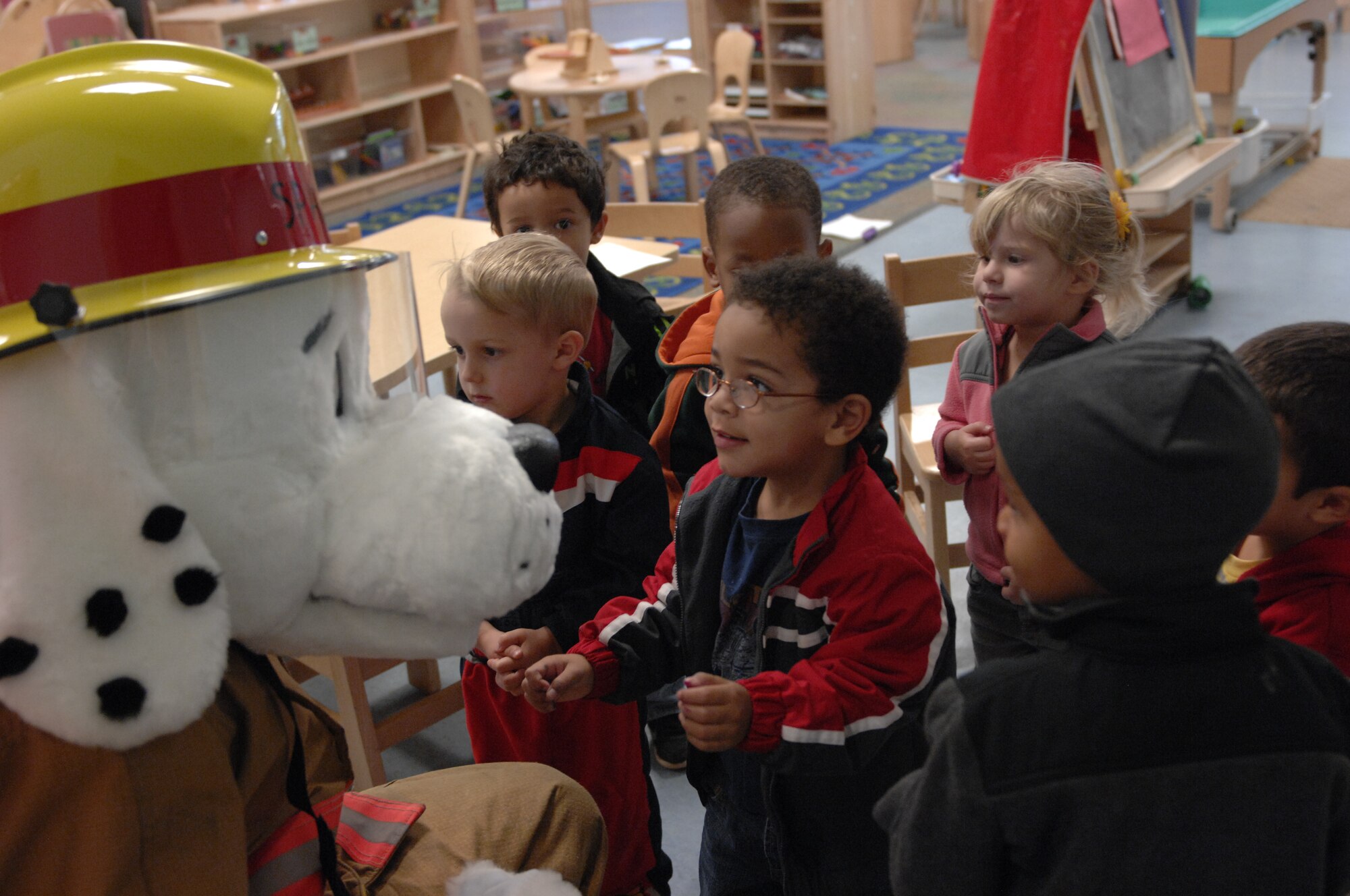 Children at the Child Development Center greet Sparky the Fire Dog at Shaw Air Force Base, S.C., Oct. 12, 2012. Sparky toured the CDC to help teach the children fire safety techniques during Fire Prevention Week. (U.S. Air Force photos by Airman 1st Class Krystal M. Jeffers/Released)