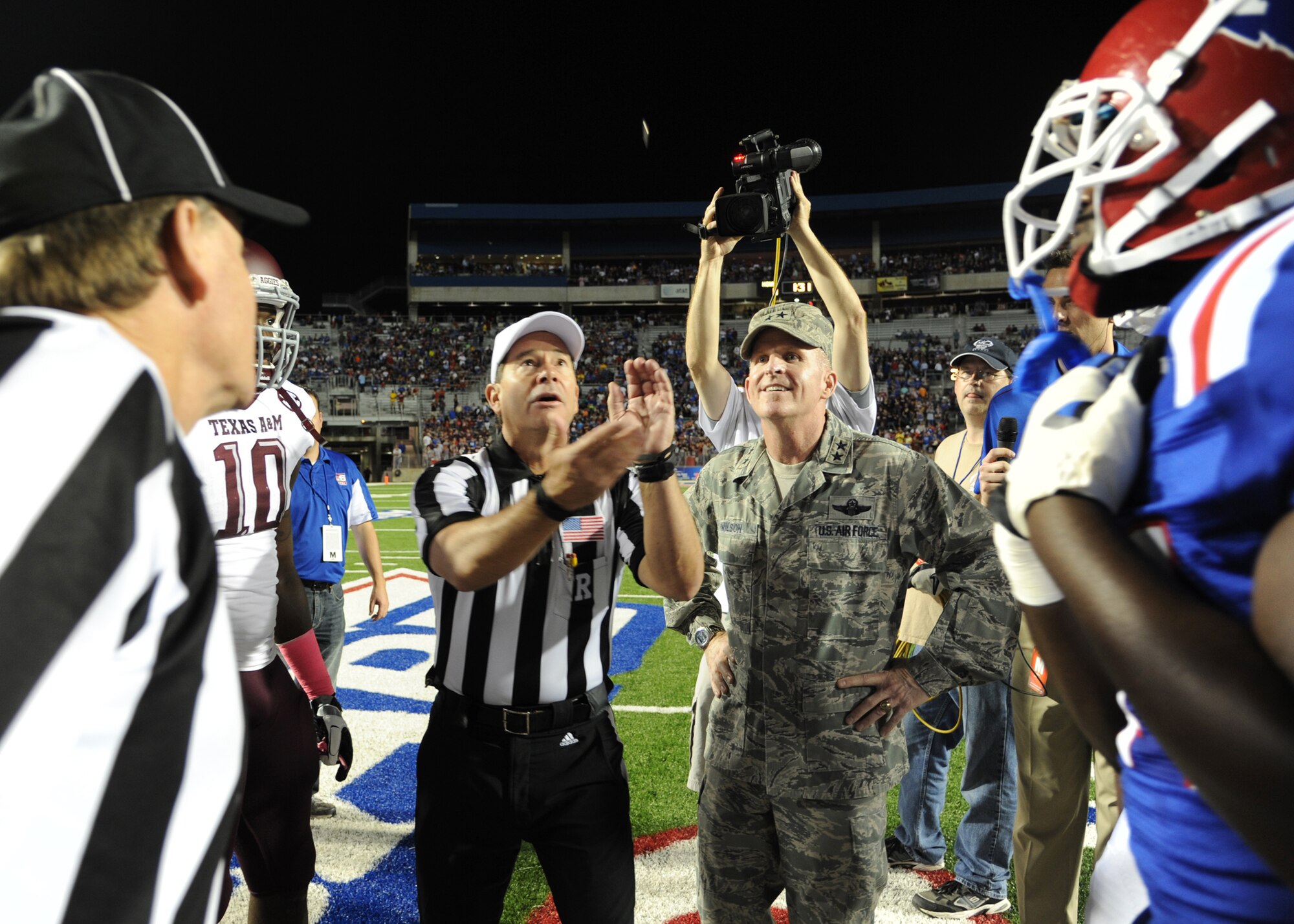 SHREVEPORT, La. -- Maj. Gen. Stephen Wilson, 8th Air Force commander, stands midfield as the referee flips the coin during pregame activities for the Texas A & M vs. Louisiana Tech football game at Independence Stadium Oct. 13. As part of the Year of the B-52, commemorating the plane’s 60th anniversary, Wilson served as the honorary captain for the game. A B-52 video was also shown on the jumbotron during halftime. (U.S. Air Force photo/Airman 1st Class Joseph A. Pagán Jr.)(RELEASED)