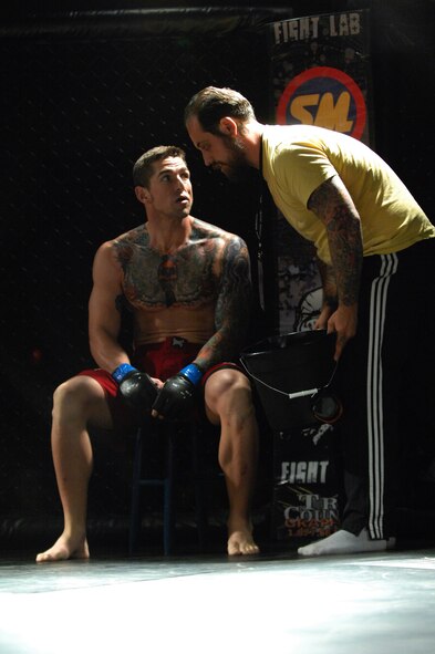 Josh Stuart and his coach talk as he recovers after the first round of his fight against Jurraun Gamble at the mixed marital arts cage fight, Shaw Air Force Base, S.C., Oct. 16, 2012.  Stuart won the fight after Gamble tapped out in the second round. (U.S. Air Force photo by Airman Nicole Sikorski/Released)