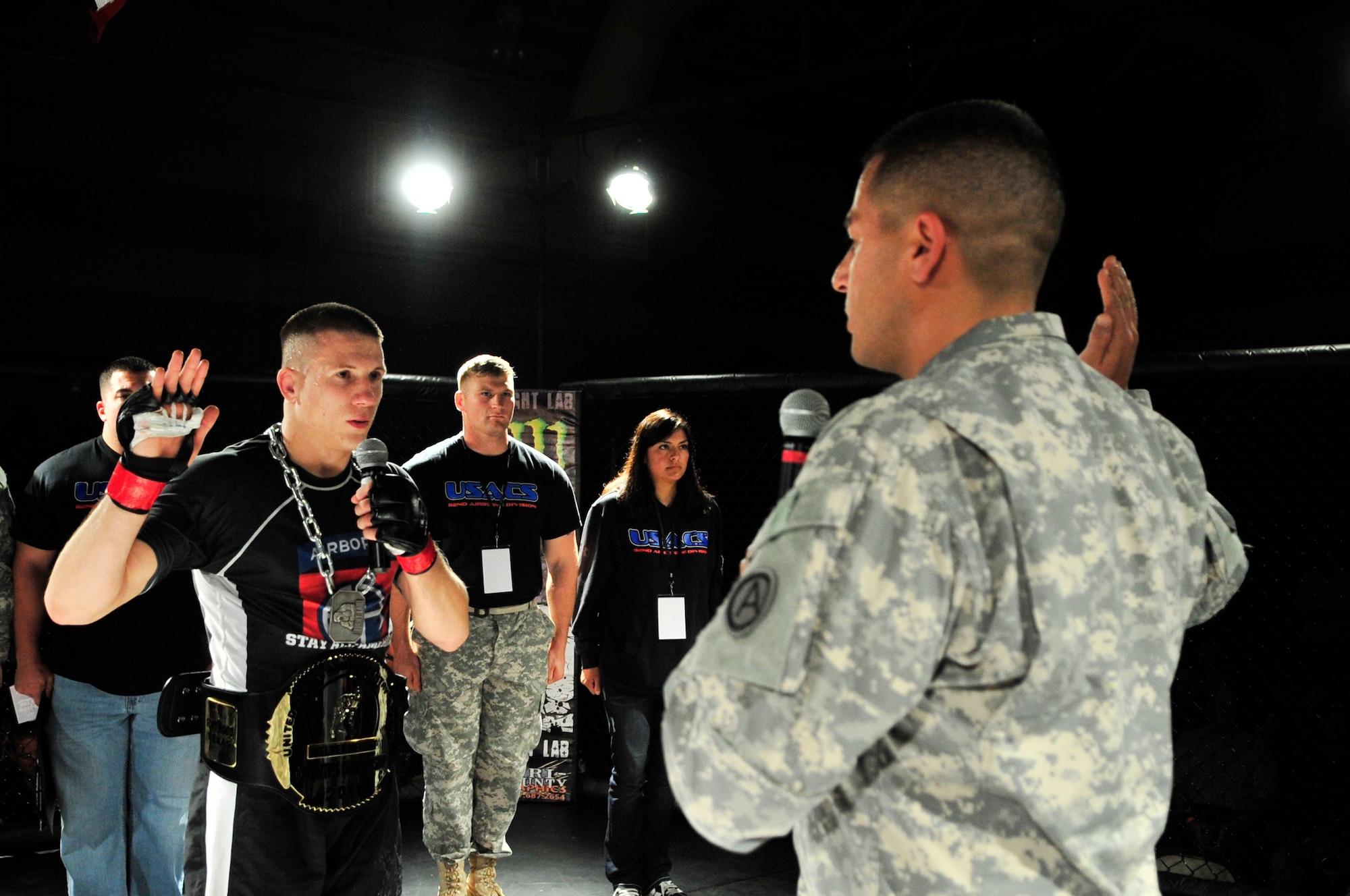 U.S. Army Sgt. Jesse Hertzog, 82nd Airborne Division reenlists after winning a cage fight against Jonathan Noah at the fitness center, Shaw Air Force Base, S.C., Oct. 12, 2012.  Hertzog along with 17 other fighters were paired together for nine fights. (U.S. Air Force photo by Airman Nicole Sikorski/Released)