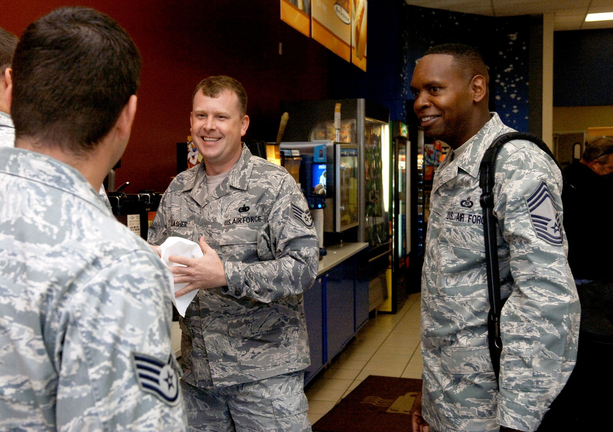 Chief Master Sgt. Tony Pearson, (right) Army & Air Force Exchange Service senior enlisted advisor, visits the base shoppette Sept. 16, 2012, at Joint Base Langley-Eustis, Va.  Pearson is one of 72 active-duty Service members assigned to Exchange to carry out its mission to provide quality products, services and food to the military community.  (U.S. Air Force Photo by Staff Sgt. Katie G. Ward / Released)