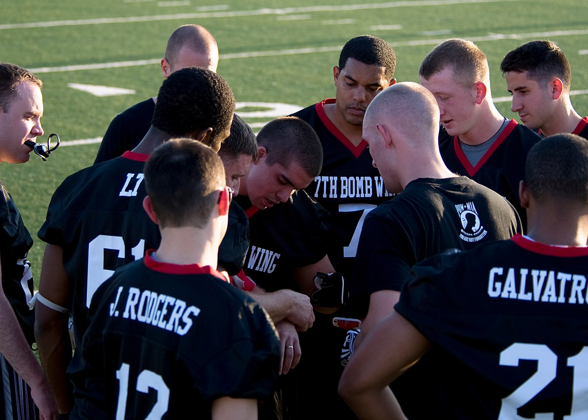 Members of the 7th Bomb Wing flag football team discuss second half adjustments Oct. 11, 2012, during a flag football game at Dyess Air Force Base, Texas. The Dyess intramural flag football league kicked off Oct. 9 and continues until November. Following the regular season, the top teams from each division will participate in a double elimination tournament to determine the 2012 Dyess flag football champions. (U.S. Air Force photo by Airman 1st Class Damon Kasberg/ Released)