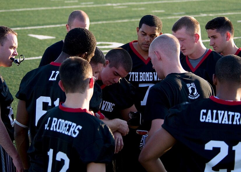 Members of the 7th Bomb Wing flag football team discuss second half adjustments Oct. 11, 2012, during a flag football game at Dyess Air Force Base, Texas. The Dyess intramural flag football league kicked off Oct. 9 and continues until November. Following the regular season, the top teams from each division will participate in a double elimination tournament to determine the 2012 Dyess flag football champions. (U.S. Air Force photo by Airman 1st Class Damon Kasberg/ Released)
