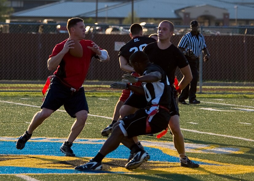 Clarion Miller, 7th Bomb Wing quarterback, identifies open receivers Oct. 11, 2012, during a flag football game at Dyess Air Force Base, Texas. The Dyess intramural flag football league kicked off Oct. 9 and continues until November. Following the regular season, the top teams from each division will participate in a double elimination tournament to determine the 2012 Dyess flag football champions. (U.S. Air Force photo by Airman 1st Class Damon Kasberg/ Released)
