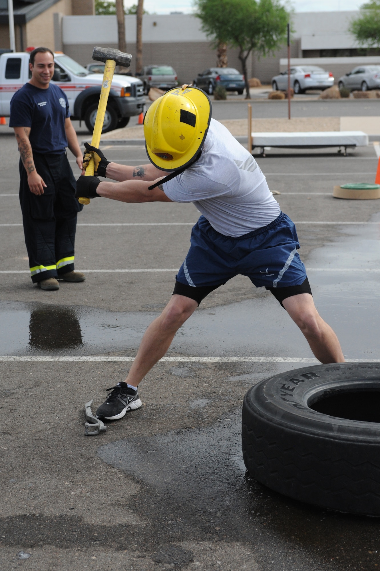 Tech. Sgt. Matthew Fligg, 56th Fore Support Squadron base and formal training NCO-in-charge, strikes a tire with a sledgehammer during the 2012 Firefighter’s Muster Oct. 12 at Luke Air Force Base, Ariz. Hit the Tire was the fifth obstacle of the competition.  Contestants had to move the tire the required distance by repeatedly striking the tire with a sledgehammer before continuing on to the next obstacle. (U.S. Air Force photo by Denise Willhite)