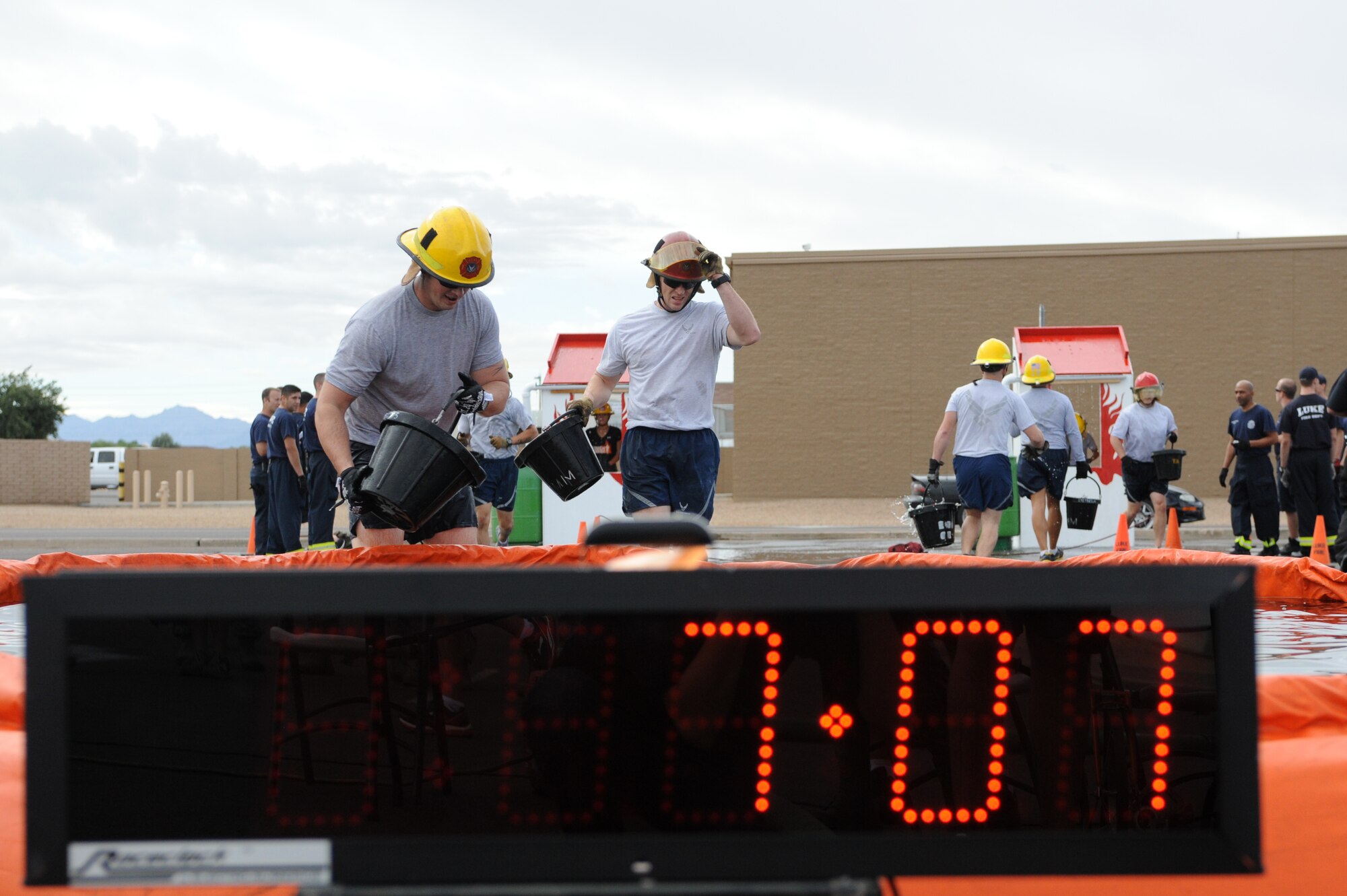 Teams consisting of four members each participate in the Bucket Brigade event as part of the 2012 Firefighter’s Muster Oct. 12 at Luke Air Force Base, Ariz. Judges consisted of two time keepers and two violation referees. Scoring was based on overall time plus any time infractions. The three teams with the best scores won first, second and third place. (U.S. Air Force photo by Denise Willhite)
