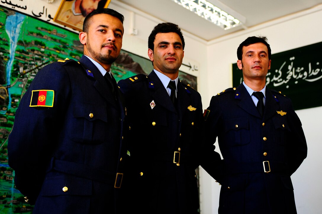 Newly graduated Afghan Air Force pilots, 1st Lt.'s Walid Noori, Emal Azizi, and Khan Agha Ghaznavi, pose for a group photo after their ceremony Oct. 15, 2012 in the wing headquarters at Shindand Air Base, Afghanistan. The lieutenants became the first fixed-wing undergraduate pilot trainees to earn their wings in Afghanistan after more than 30 years, completing the entire fixed-wing program entirely in Afghanistan. (U.S. Air Force photo/Tech. Sgt. Quinton Russ/RELEASED)
