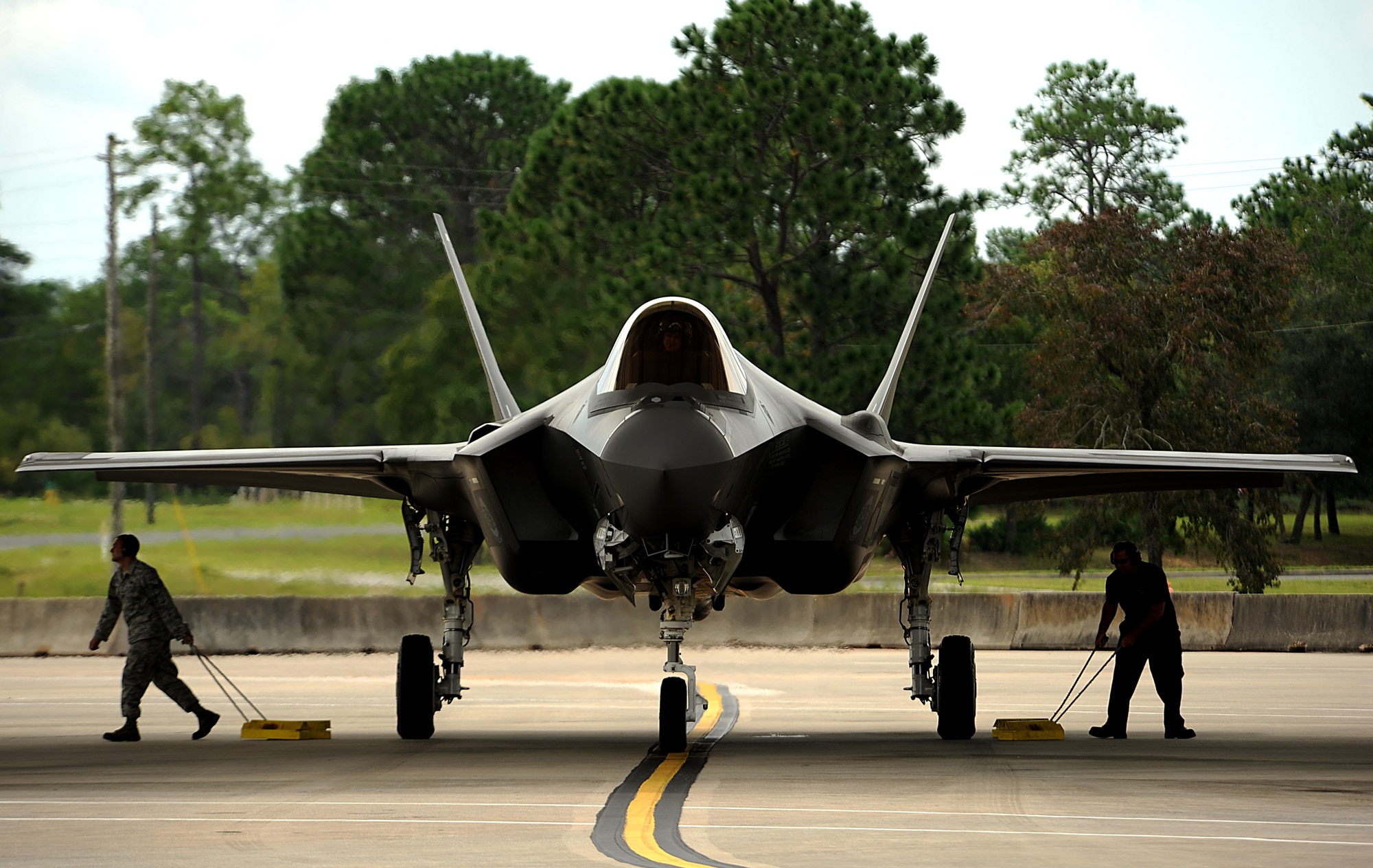 F-35A Lightning II joint strike fighter crew chief Staff Sgt. Darron Cothran (left) and a Lockheed Maintainer from the 58th Aircraft Maintenance Unit at Eglin Air Force Base, Fla., pull the wheel chalks on the jet before taking off for a local training mission over the Emerald Coast Sept. 18, 2012.  (U.S. Air Force photo/Master Sgt. Jeremy T. Lock)