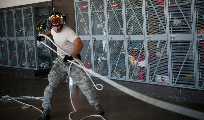 A firefighter from the 23d Civil Engineer Squadron pulls a rolled fire hose during a Fire Muster Challenge at Moody Air Force Base, Ga., Oct. 12, 2012. The challenge was held in support of National Fire Prevention Week, a week focused on fire safety and prevention. (U.S. Air Force photo by Senior Airman Douglas Ellis/Released)
