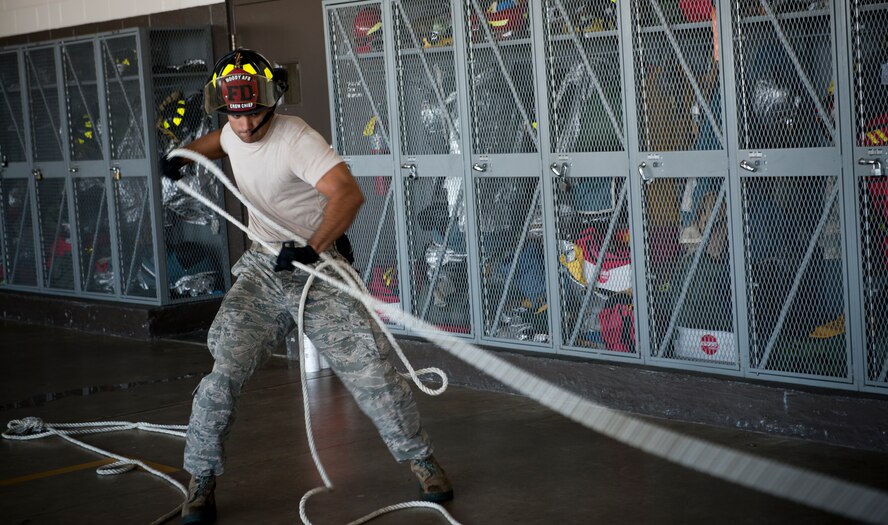 A firefighter from the 23d Civil Engineer Squadron pulls a rolled fire hose during a Fire Muster Challenge at Moody Air Force Base, Ga., Oct. 12, 2012. The challenge was held in support of National Fire Prevention Week, a week focused on fire safety and prevention. (U.S. Air Force photo by Senior Airman Douglas Ellis/Released)
