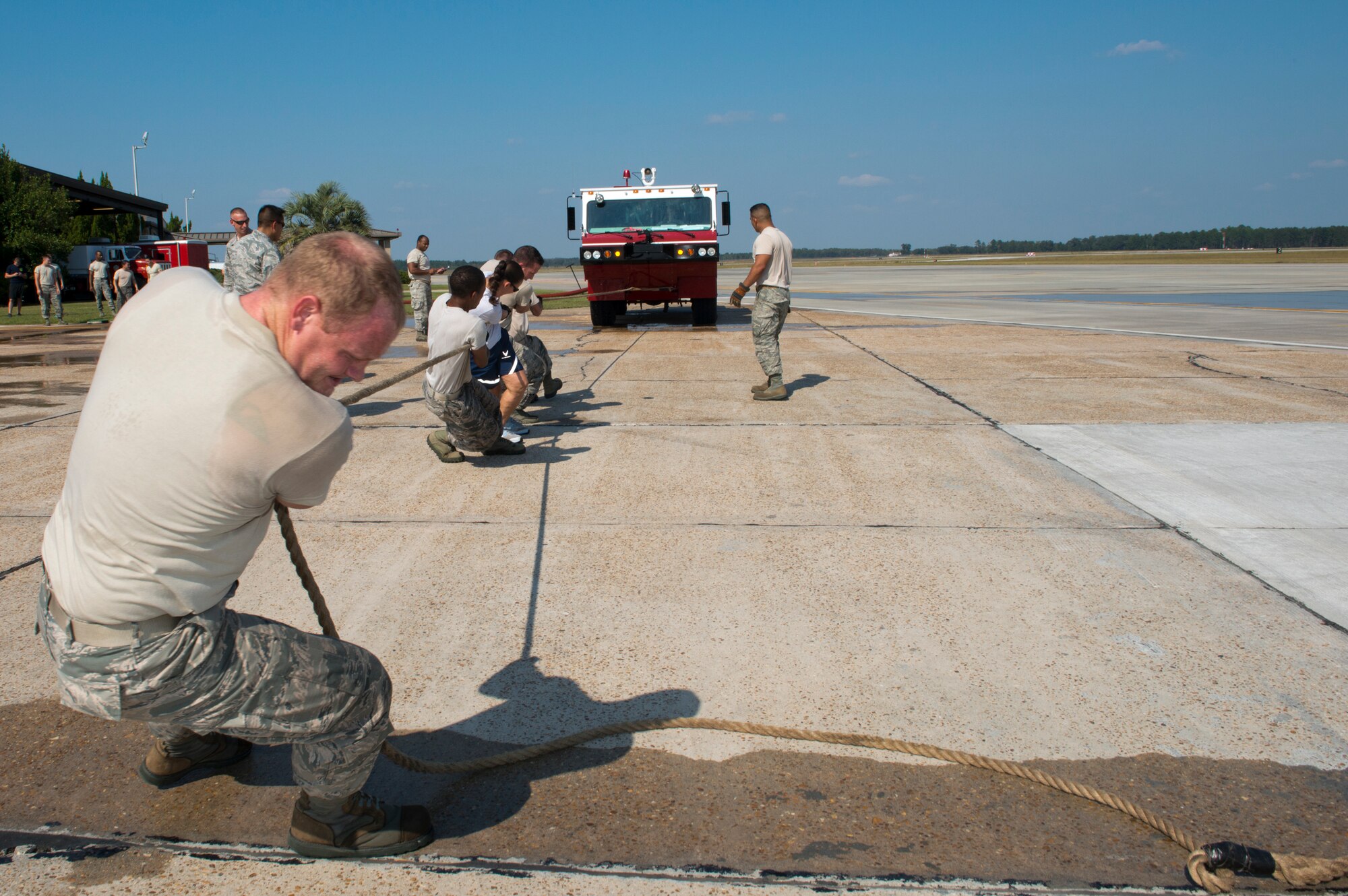 Moody Airmen pull a P-19 fire truck during a Fire Muster Challenge at Moody Air Force Base, Ga., Oct. 11, 2011. The team competed to pull the truck a distance of 25 feet as fast as possible. (U.S. Air Force photo by Senior Airman Douglas Ellis/Released)
