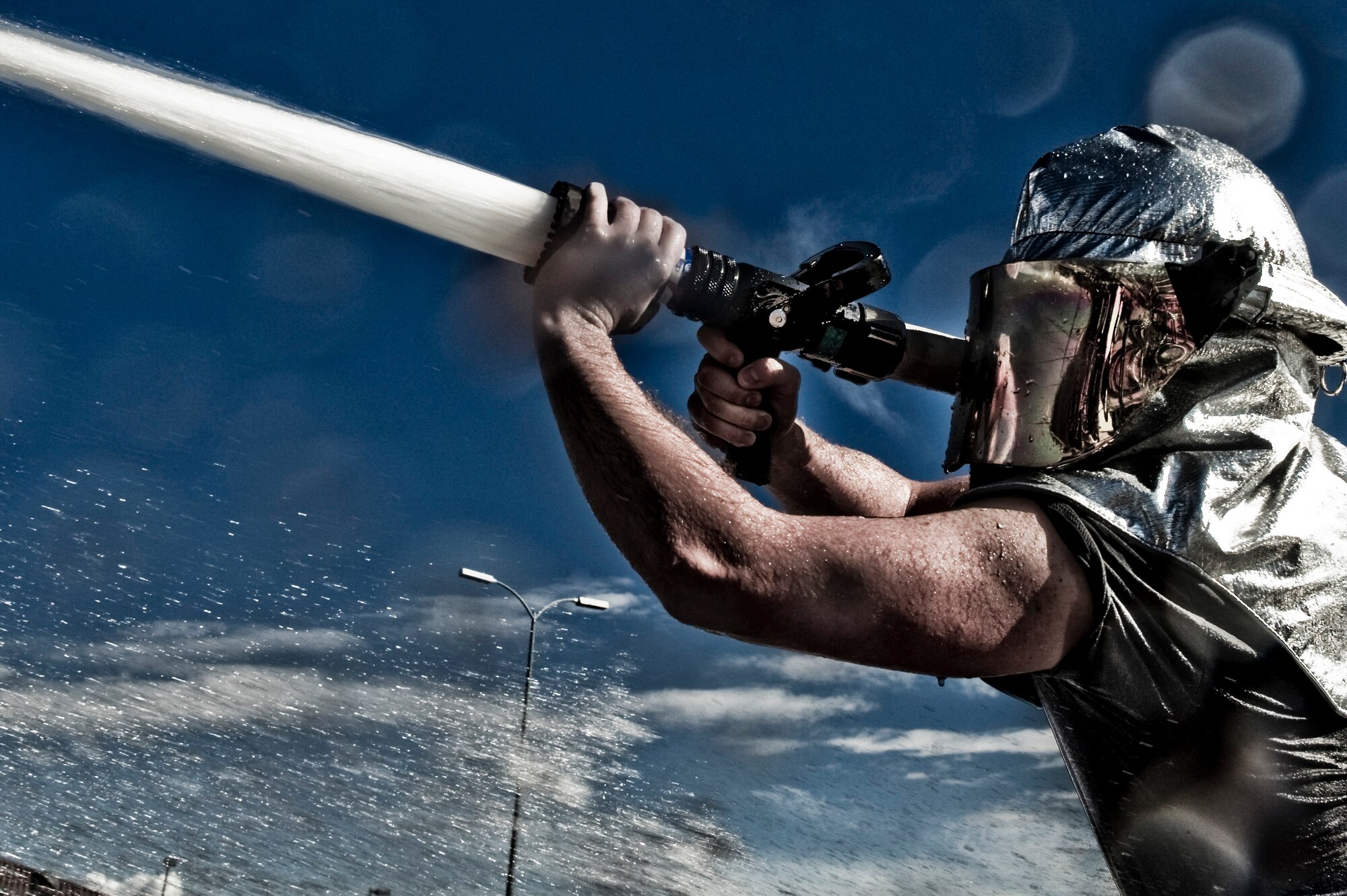 A U.S. Air Force Airman participates in a water hose tug-of-war during the fifth annual Fire Muster competition at the Sports Pavilion Oct. 12, 2012, at Nellis Air Force Base, Nev. The winning teams from each primary round face off to find the overall winner for each event. The team with the most points at the end of the five stages claimed the prize of being the Nellis 2012 Fire Muster champions.  (U.S. Air Force photo by Senior Airman Daniel Hughes)