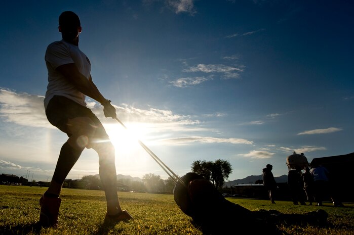 Senior Airman Michael Bilodeau, 99th Logistics Readiness Squadron petroleum, oil, and lubricants journeyman, drags a simulated body for more than 20 yards during the fifth annual Fire Muster competition at the Sports Pavilion Oct. 12, 2012, at Nellis Air Force Base, Nev. The 99th Civil Engineer Squadron fire department organizes the fire muster for squadrons to come together and compete against each other in support of fire prevention week. (U.S. Air Force photo by Senior Airman Daniel Hughes)