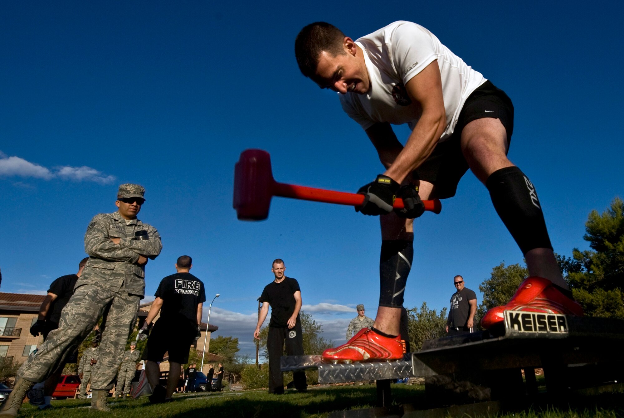 U.S. Air Force Senior Airman Michael Bilodeau, 99th Logistics Readiness Squadron petroleum, oil, and lubricants journeyman, swings a sledge hammer on the Keiser sled portion of the confidence course during the fifth annual Fire Muster competition at the Nellis Sport Pavilion Oct. 12, 2012, at Nellis Air Force Base, Nev. The Fire Muster is the culmination of fire prevention week, as proclaimed by the 99th Air Base Wing commander. (U.S. Air Force photo by Senior Airman Daniel Hughes)