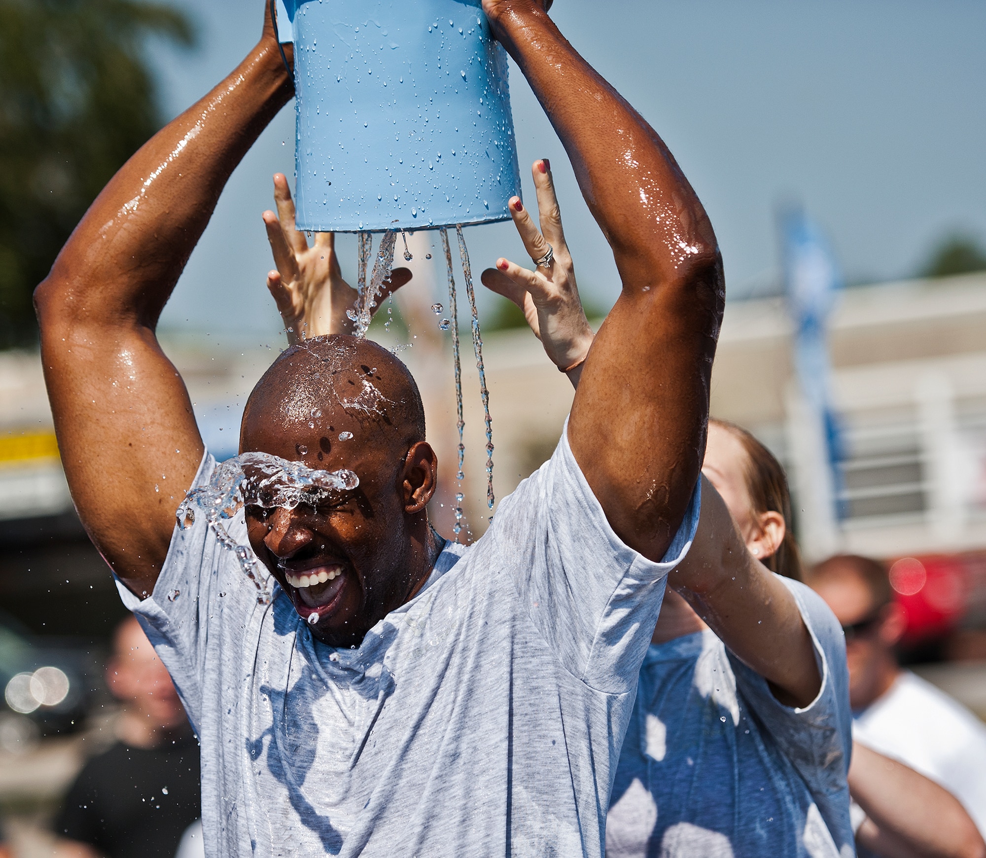 A Team Eglin Airman passes a bucket of water back during the annual fire muster challenge that concluded fire prevention week at Eglin Air Force Base, Fla., Oct. 12.  Teams competed in the challenge that included a ladder and hose carry, fire engine pull, and water relay. (U.S. Air Force photo/Samuel King Jr.)