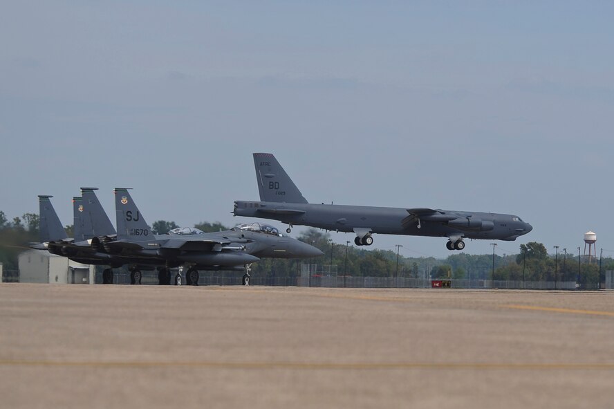 F-15E Strike Eagles from Seymour Johnson Air Force Base, N.C., stand by to launch as a B-52H Stratofortress lands on Barksdale Air Force Base, La., Oct. 12. The F-15s deployed to Barksdale to practice close air support for joint terminal attack controllers attached to Army units as a part of exercise Green Flag East. (U.S. Air Force photo/Senior Airman Micaiah Anthony)(RELEASED)