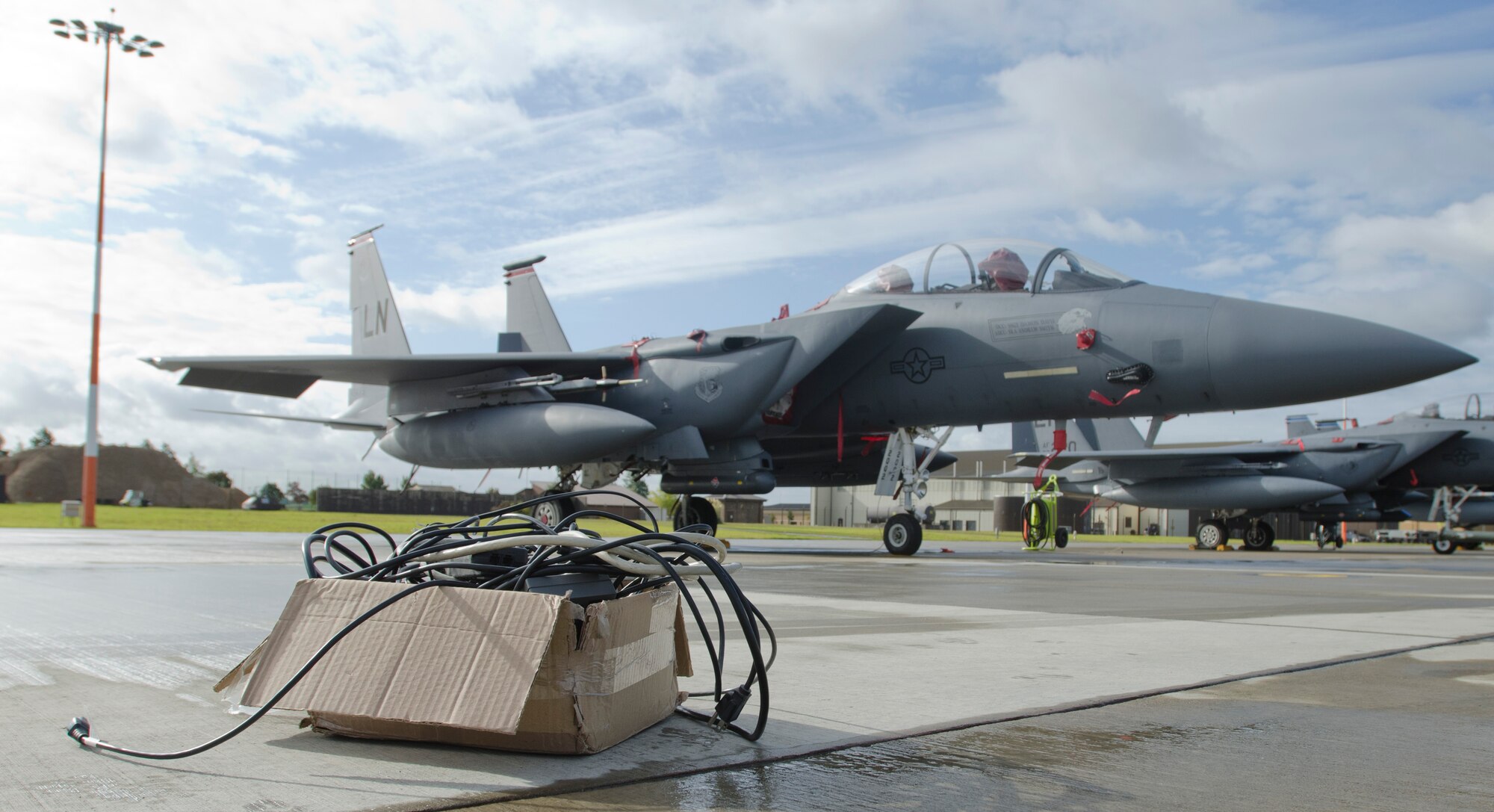 ROYAL AIR FORCE LAKENHEATH, England - A box of 120-volt, U.S. specification, power cords sits in front of an F-15E Strike Eagle Oct. 12. The 48th Fighter Wing is currently switching these cords with 240-volt, European specification, power cords on dual-voltage devices as a part of the Transformer Cut Off Initiative, a U.S. Air Forces in Europe-wide energy savings initiative. The initiative is slated to save the 48th FW $750,000 per year. (U.S. Air Force photo by Staff Sgt. Stephen Linch)