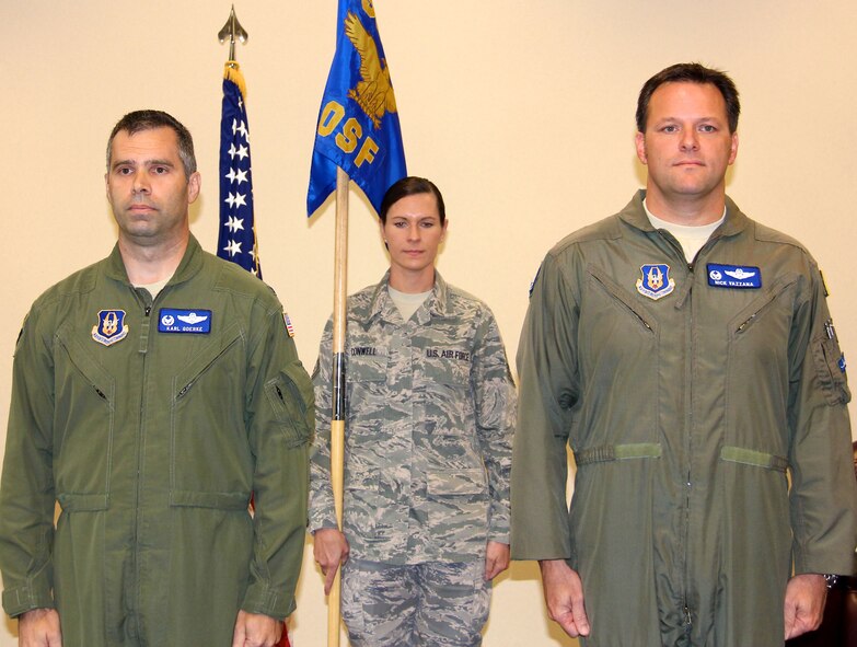 Lt. Col. Nicholas Vazzana, (right) is the new commander of the 932nd Operations Support Flight.  Col. Karl Goerke, 932nd Operations Group commander, (left)  presided at the assumption of command ceremony held Oct. 13, 2012 on Scott Air Force Base, Ill.  Holding the unit guidon is Master Sgt. Wendi Conwell. The 932nd Airlift Wing, Air Force Reserve, flies the C-40C aircraft. (Photo by Tech. Sgt. Viveka Ferrell) 