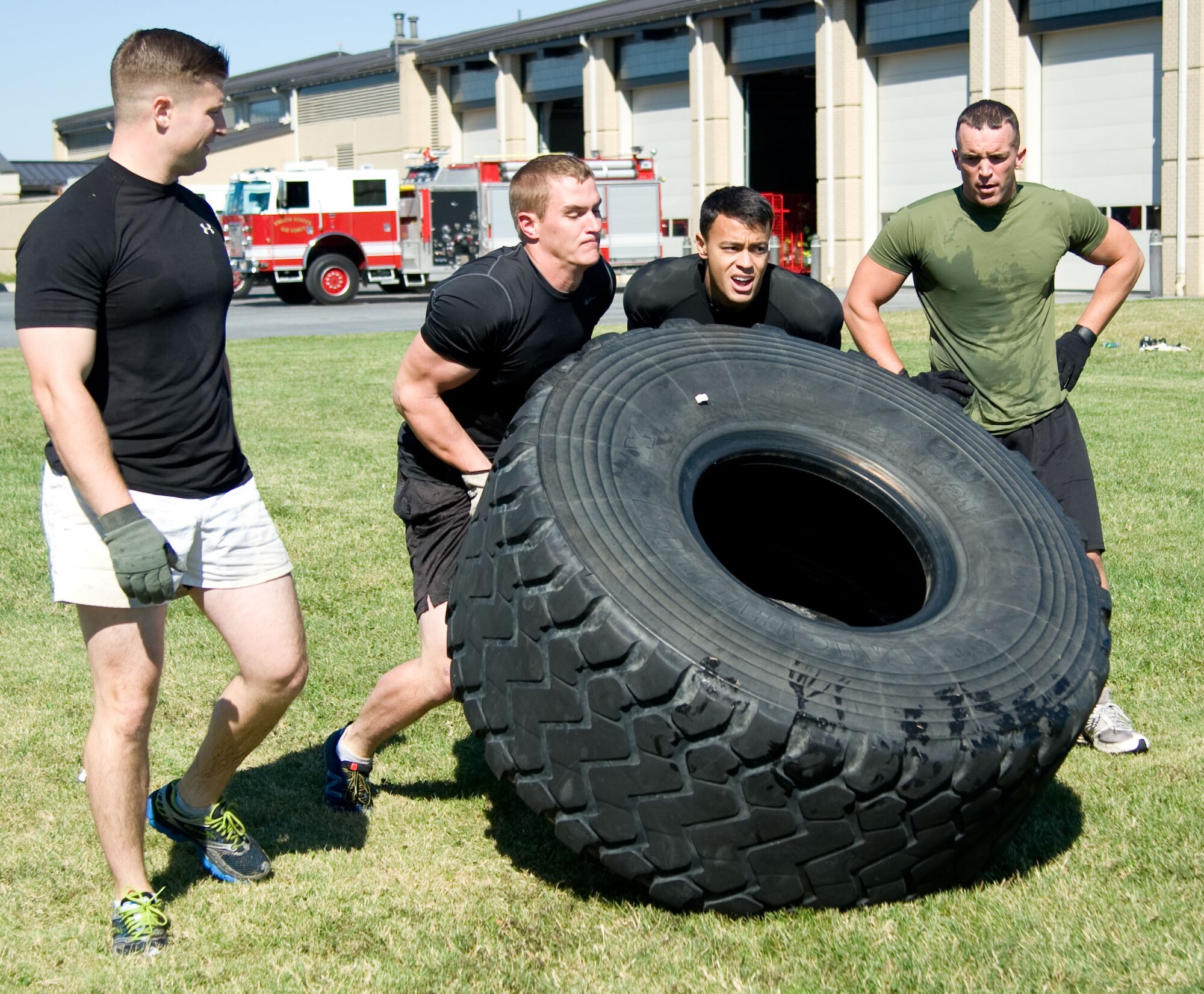 Members of the Air Force Mortuary Affairs Operations office compete in the 2012 436th Fire Department Muster Oct. 11, 2012, at Dover Air Force Base, Del. The Muster, held as part of Fire Prevention Week, simulated tasks that fireman must accomplish while on the job. (U.S. Air Force photo by Adrian R. Rowan)
