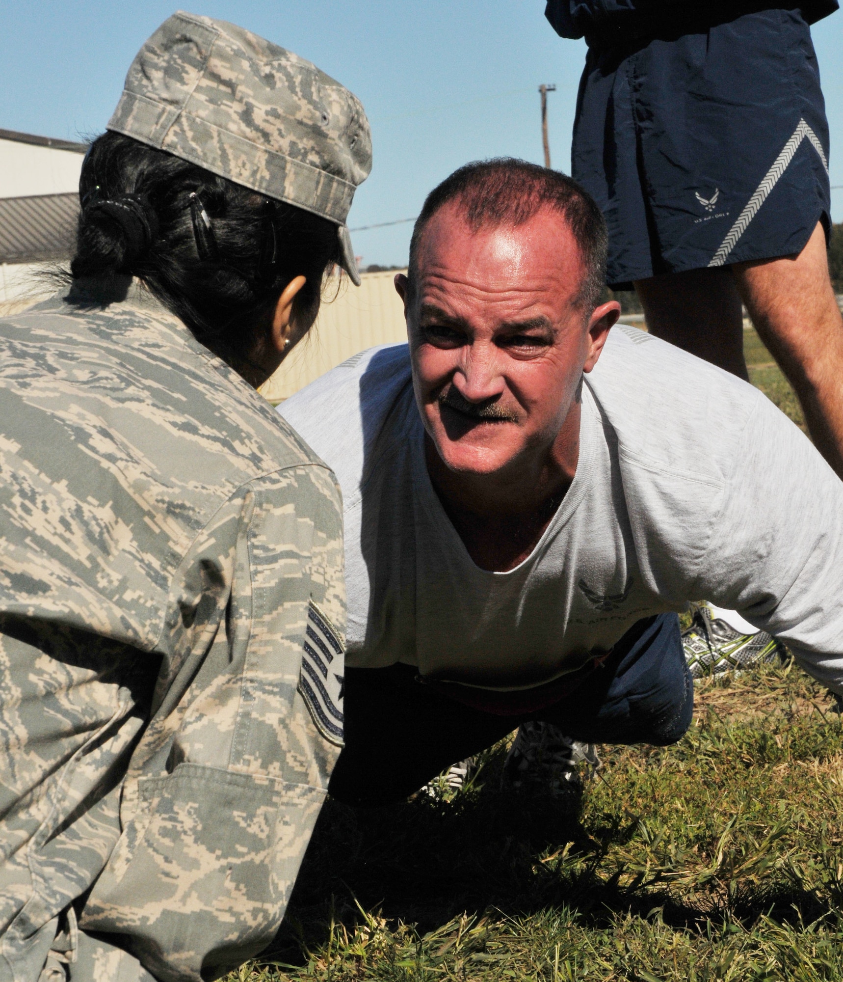Tech. Sgt. Rick Scully, a 512th Maintenance Squadron sheet metal mechanic, asks his counter the number of pushups he's completed at the Ultimate Fitness Challenge Oct. 13 at the base track. Dozens of Dover reservists competed in the event, which featured contests in sit-ups, pushups, relay race, lap walk and tug-of-war. Photo by Senior Airman Joe Yanik)