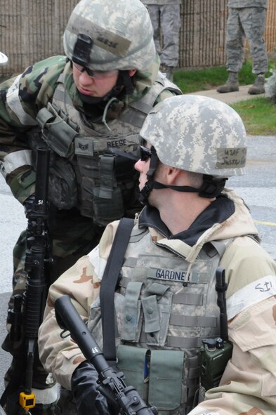 Tech. Sgt. Justin Gardner and Staff Sgt. Jonathan Reese, 193rd Special Operation Security Forces Squadron members, secure an intersection on base during an Operational Readiness Exercise, Oct. 7, 2012. Securing the intersection was part of a security measure in response to a simulated sniper on base that had fired shots. The ORE is in preparation for an Operational Readiness Inspection happening next month.  (Photo by: Air National Guard Photographer, TSgt Culeen Shaffer)