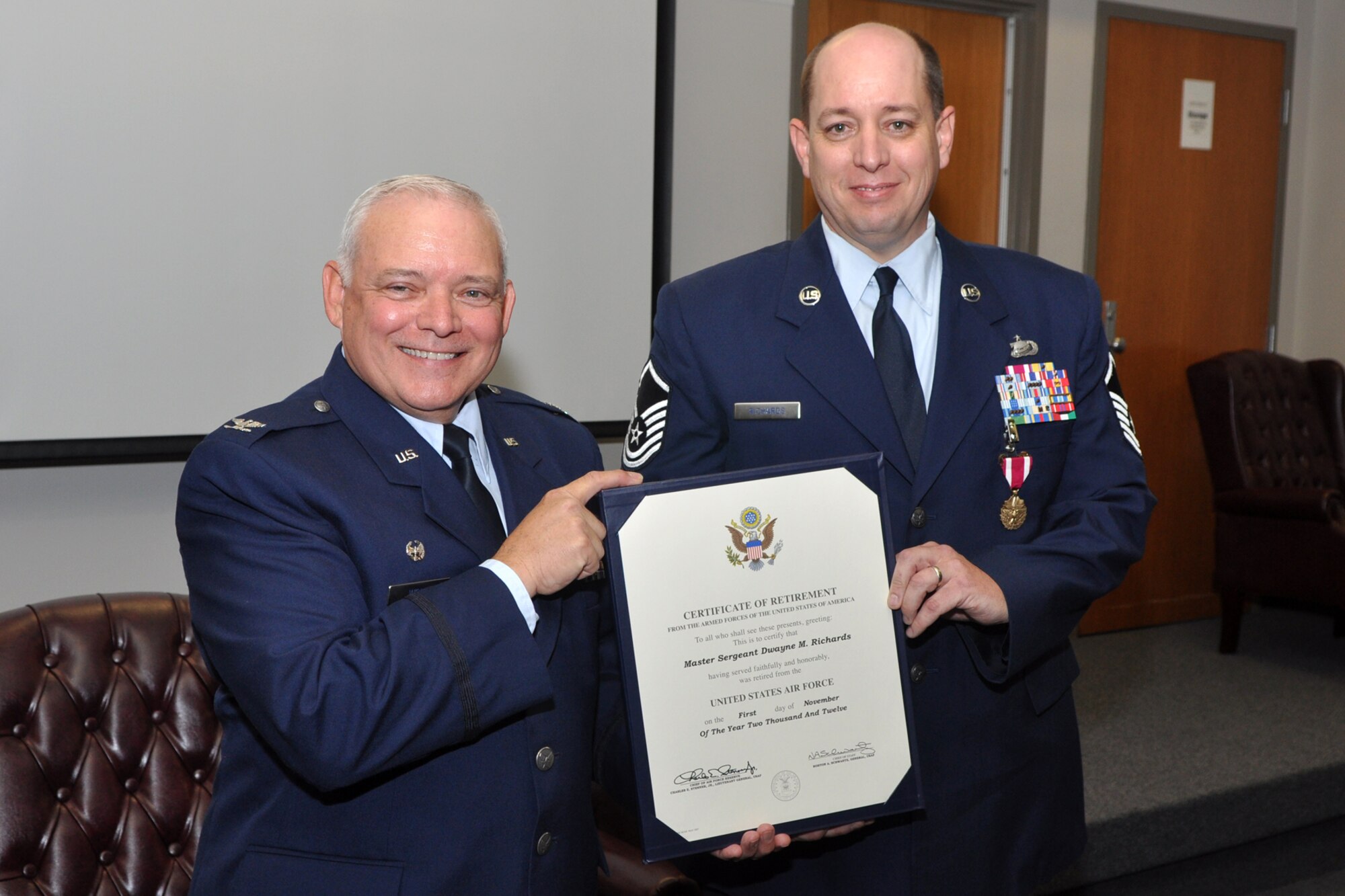 Col. Kevin Wolfe, commander, 307th Mission Support Group, poses for a photo with Master Sgt. Dwayne Richards during his retirement ceremony at Barksdale Air Force Base, La., Oct. 14, 2012. Richards retired from the Air Force Reserve, but will still do his job with the 307th Bomb Wing as a civilian employee. (U.S. Air Force photo by Master Sgt. Jeff Walston/Released)  