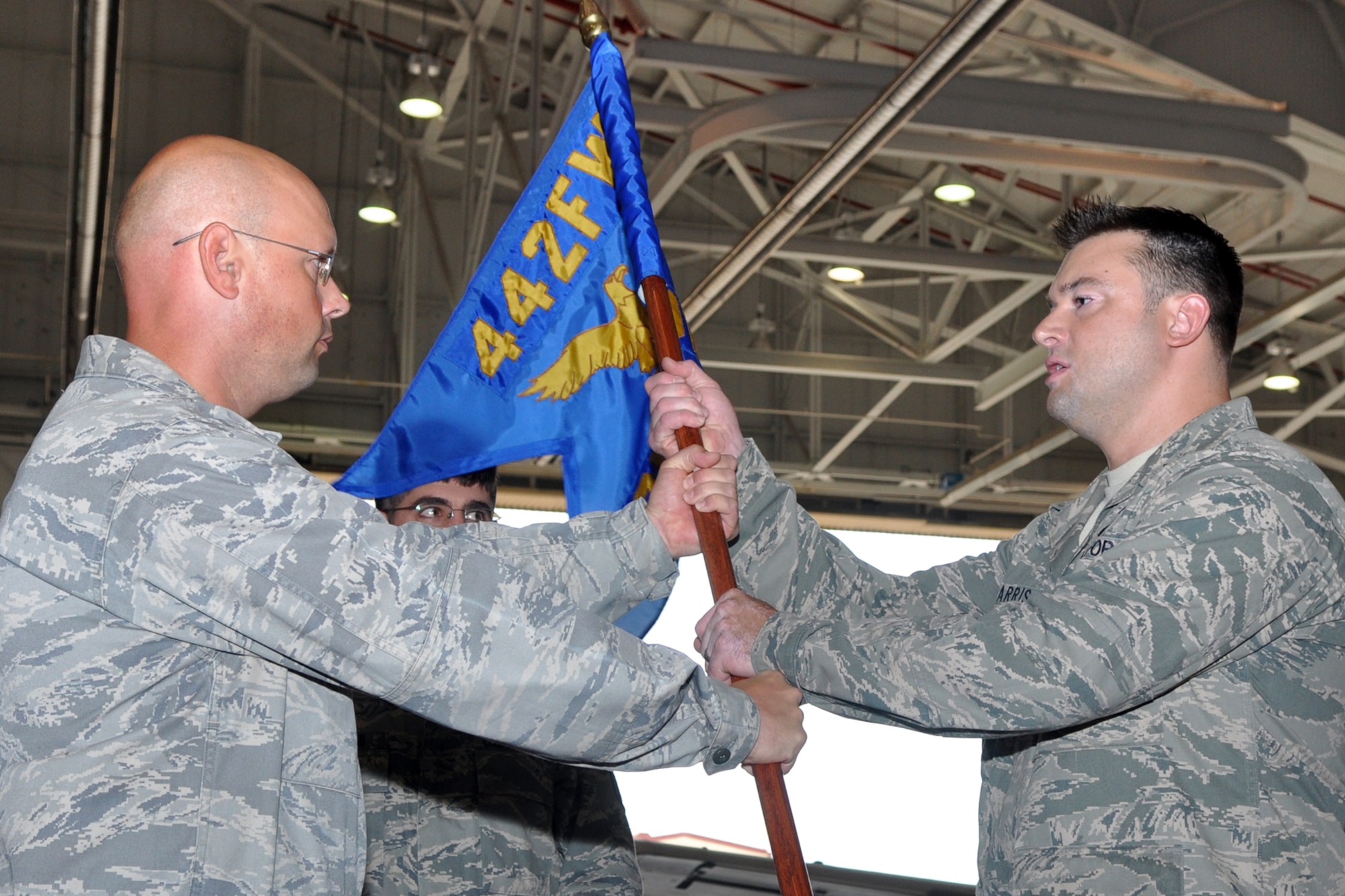 Major Cliff B. Harris accepts the flag of the 307th Maintenance Operations Flight from Lt. Col. Travis S. Caughlin, deputy commander, 917th Fighter Group during an Assumption of Command ceremony in the A-10 Hangar at Barksdale Air Force Base, La., Oct. 14, 2012. As commander, Harris will oversee the flight activities of the Maintenance Operations Center, Maintenance Training, Analysis, Engine Management, Plans and Scheduling, and Programs and Resources. (U.S. Air Force photo by Master Sgt. Jeff Walston/Released)  