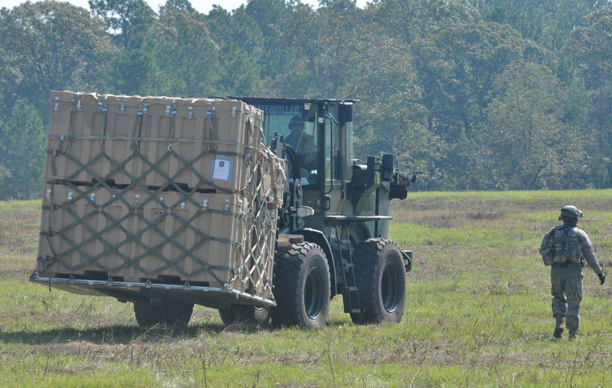 Cargo and supplies are forklifted to their appropriate location during a Joint Readiness Training Center exercise Oct. 11, 2012, at Ft. Polk La. The forklifts and supplies were used by Airmen and Soldiers already encamped in The Box, the play-zone for the exercise. (U.S. Air Force photo by Staff Sgt. Jacob Barreiro)