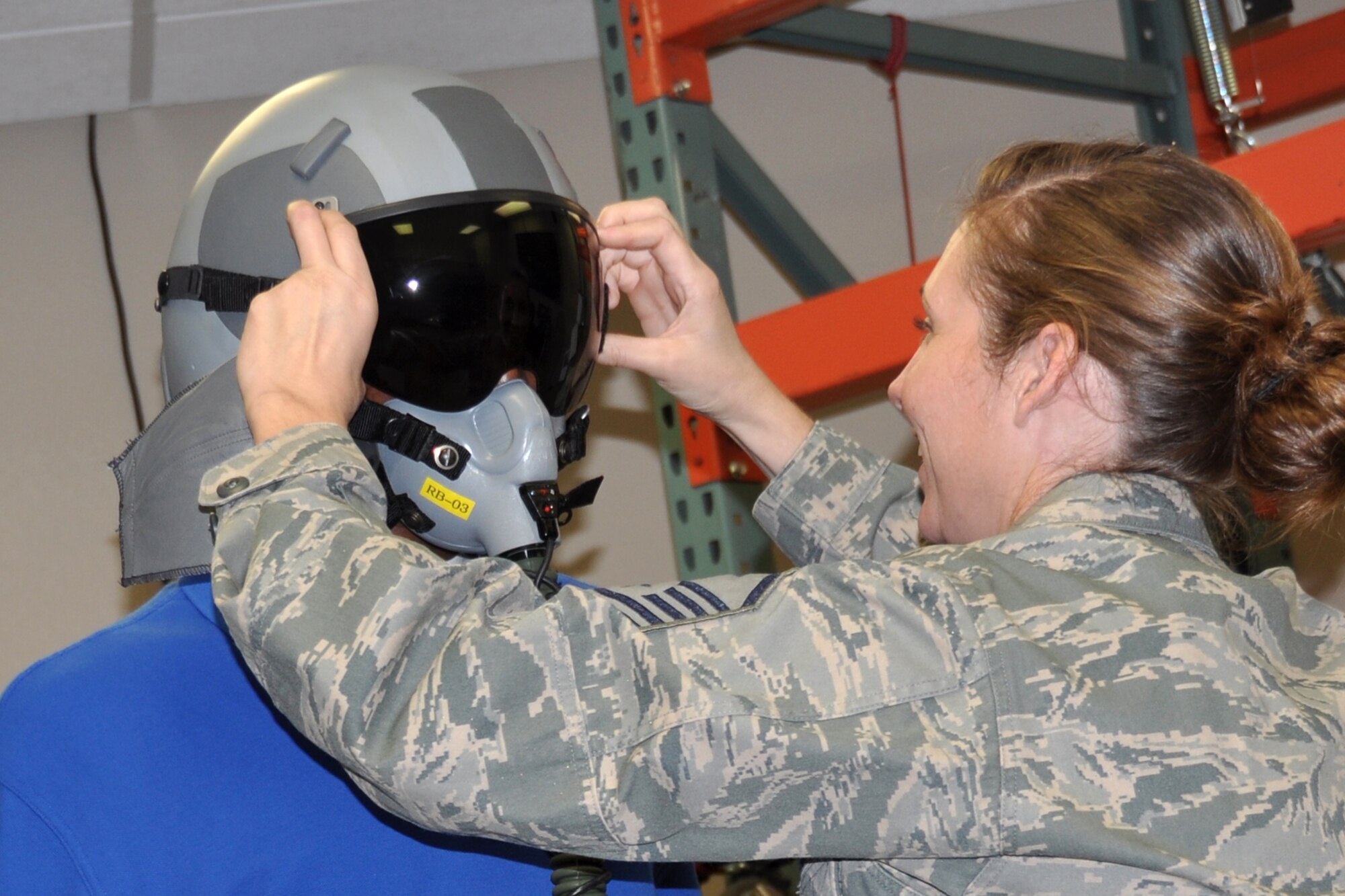Master Sgt. Andre Menard, who is an aircrew flight equipment technician assigned to the 917th Fighter Group, adjusts the visor on a visiting cadet at Barksdale Air Force Base, La., Oct. 13, 2012. A group of cadets from the Air Force ROTC Detachment 305 at Louisiana Tech University visited Barksdale to get a close up look at the B-52 Stratofortress and the A-10 Thunderbolt II. (U.S. Air Force photo by Betty Stephens/Released)  