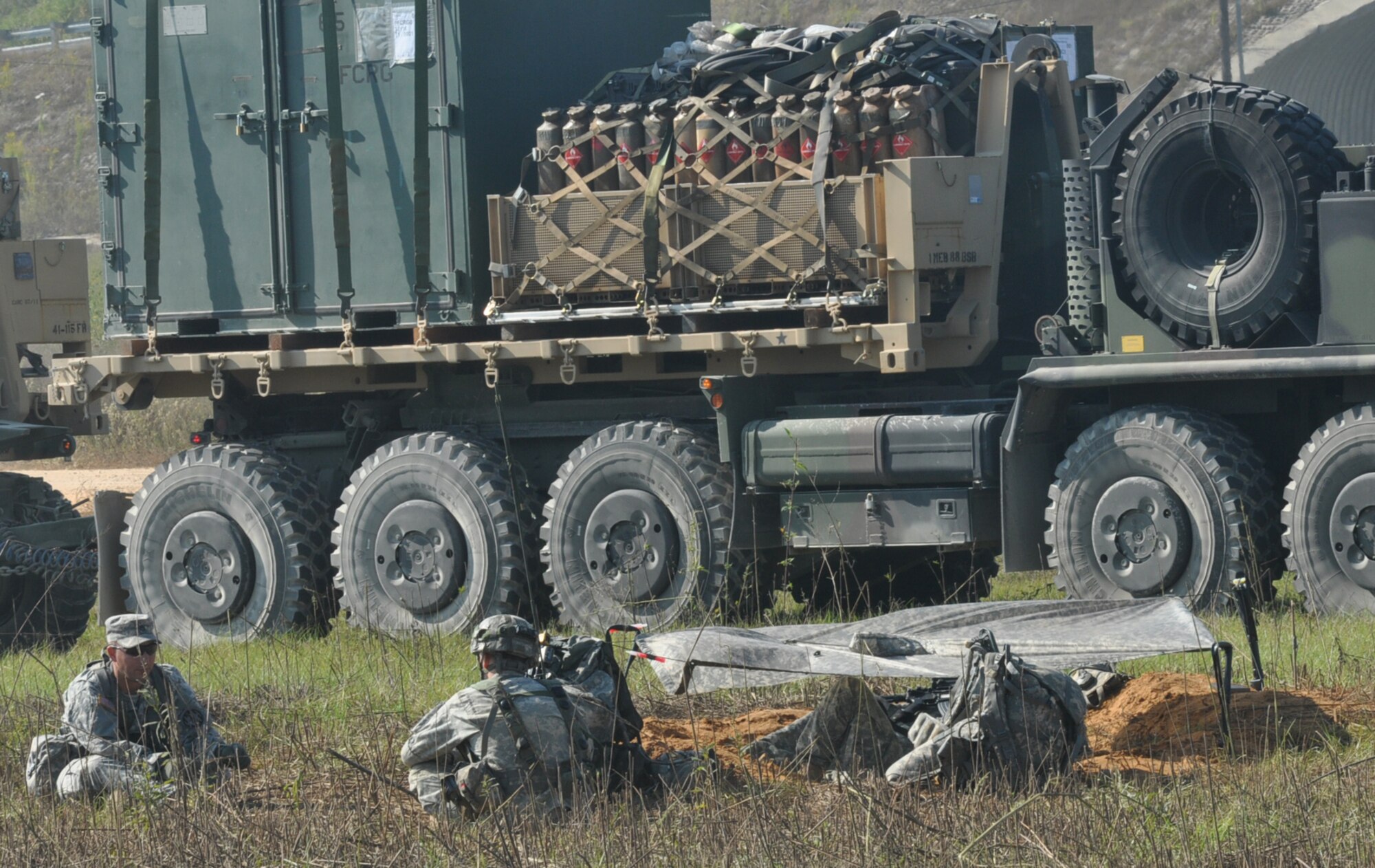 Soldiers have a discussion next to the holes they slept in during a Joint Readiness Training Center exercise Oct. 11, 2012, at Ft. Polk, La. More than 5,000 Airmen and Soldiers participated in the exercise, which was designed to test their joint capability in an expeditionary environment. (U.S. Air Force photo by Staff Sgt. Jacob Barreiro)

