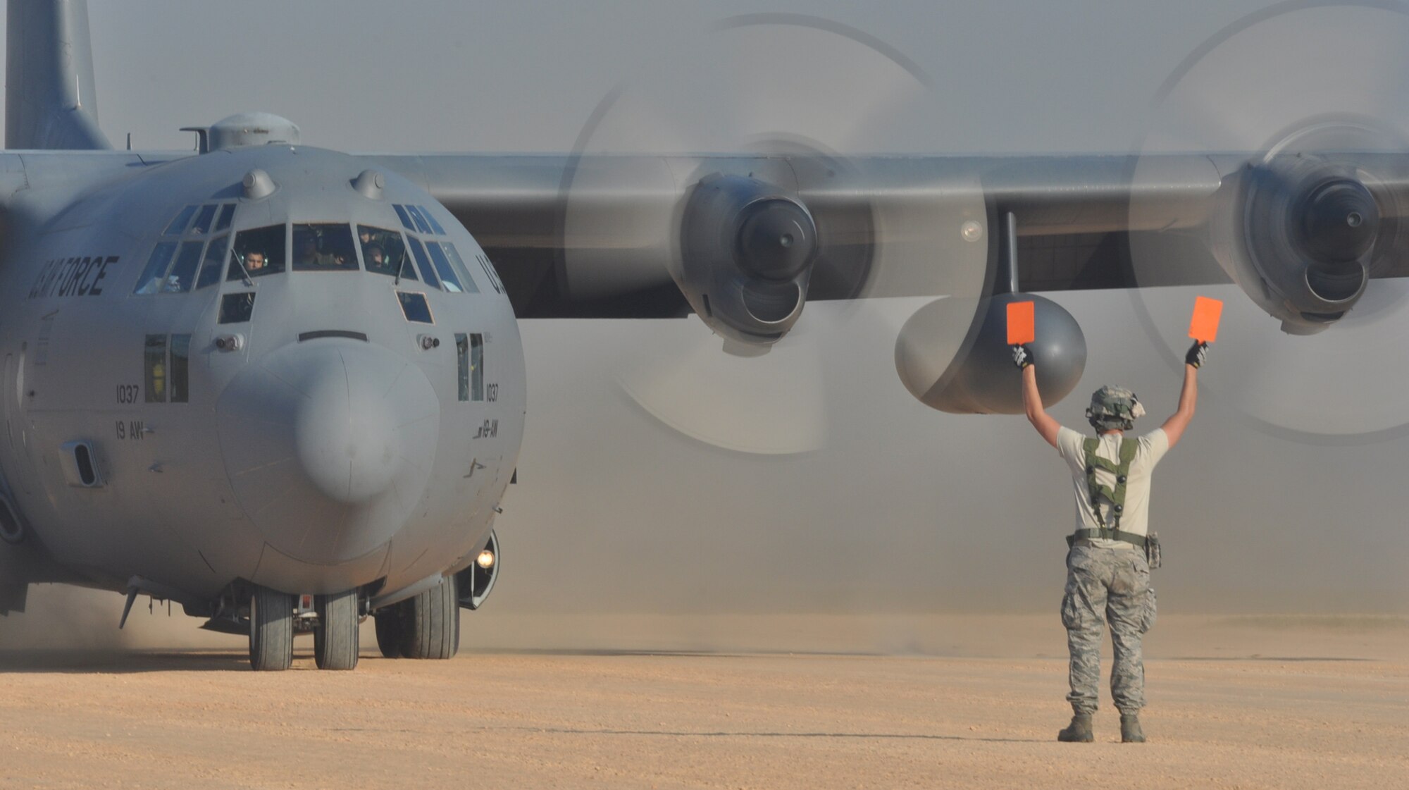 An Airman directs a C-130 on the landing zone during a Joint Readiness Training Center exercise Oct. 11, 2012, at Ft. Polk, La. Aircraft flew to and from the landing zone continuosly throughout the exercise, one of the largest the JRTC has conducted in years. (U.S. Air Force photo by Staff Sgt. Jacob Barreiro)