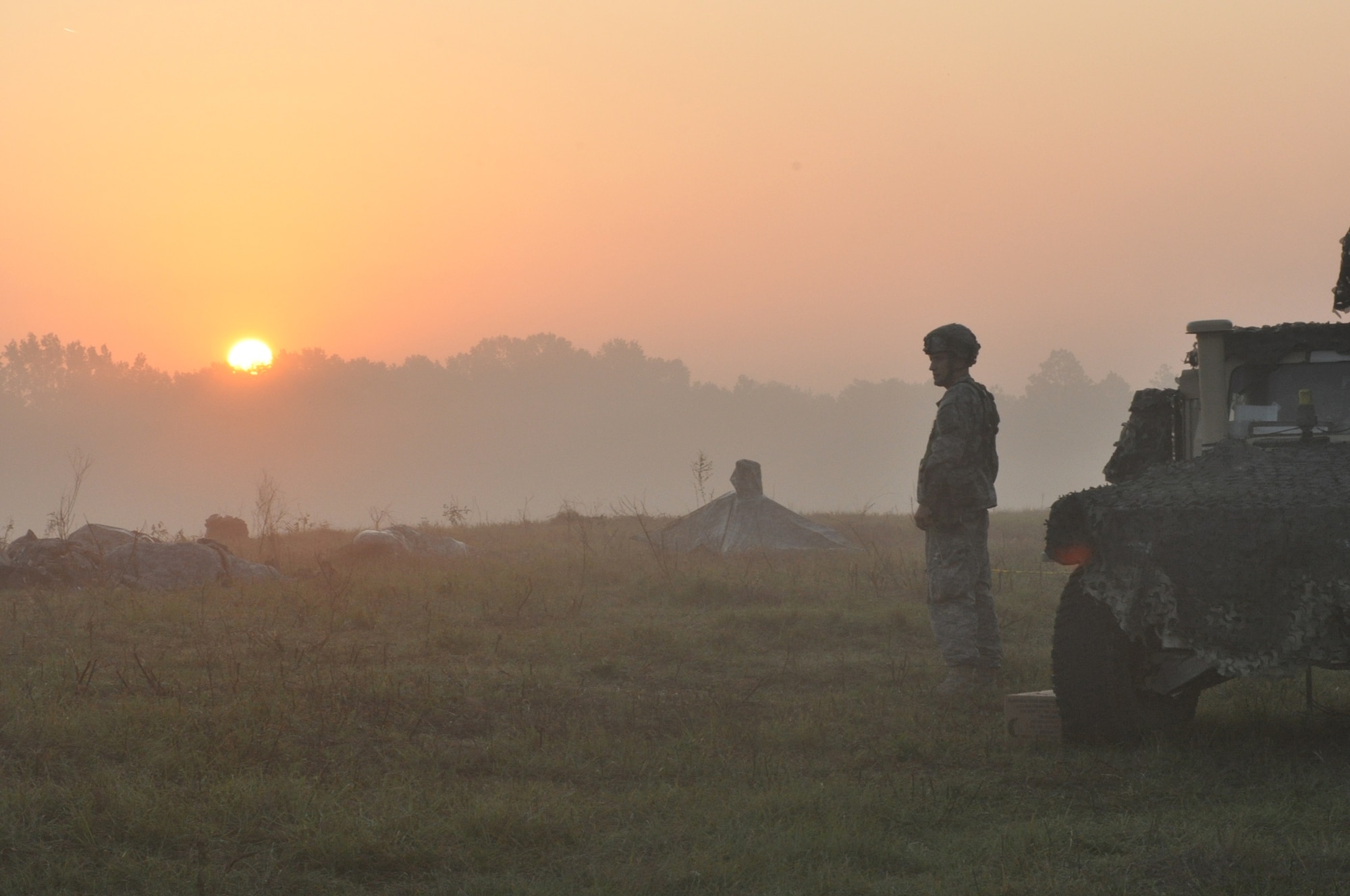 The sun appears over the treeline and dawns on Airmen and Soldiers sleeping outside during a Joint Readiness Training Center exercise Oct. 11, 2012, at Ft. Polk La. The exercise simulated a joint force’s capability to operate in a contentious environment. (U.S. Air Force photo by Staff Sgt. Jacob Barreiro)
 
